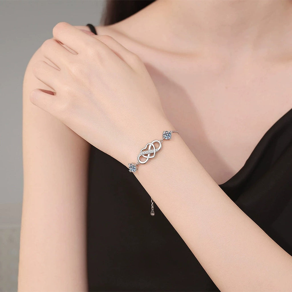 Infinity Heart Moissanite Chain Bracelet with CZ in White Gold-Plated S925 Sterling Silver worn on wrist model view showing scale and fit