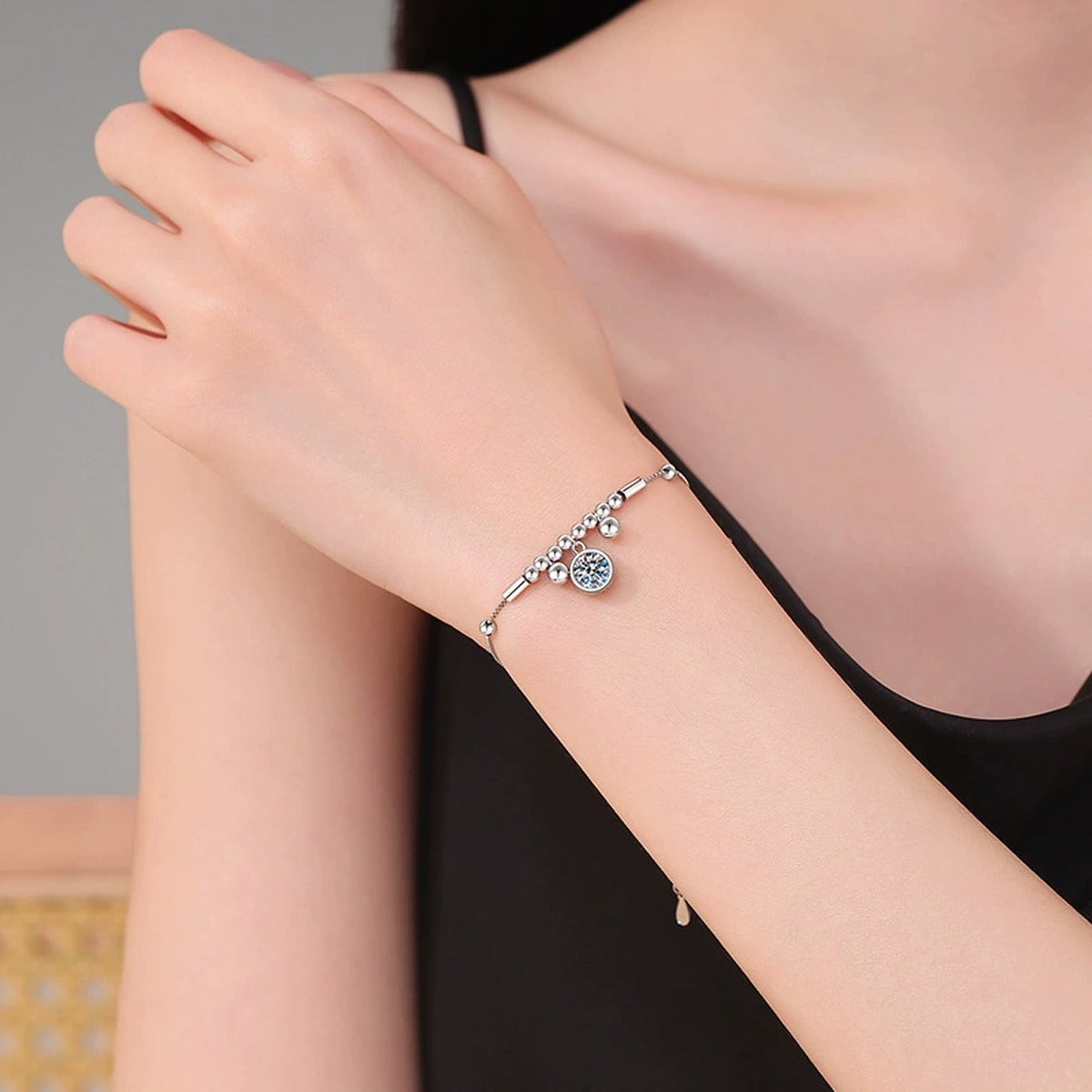 Round Moissanite Charm Bracelet in White Gold-Plated S925 Sterling Silver worn on wrist model view showing scale and fit