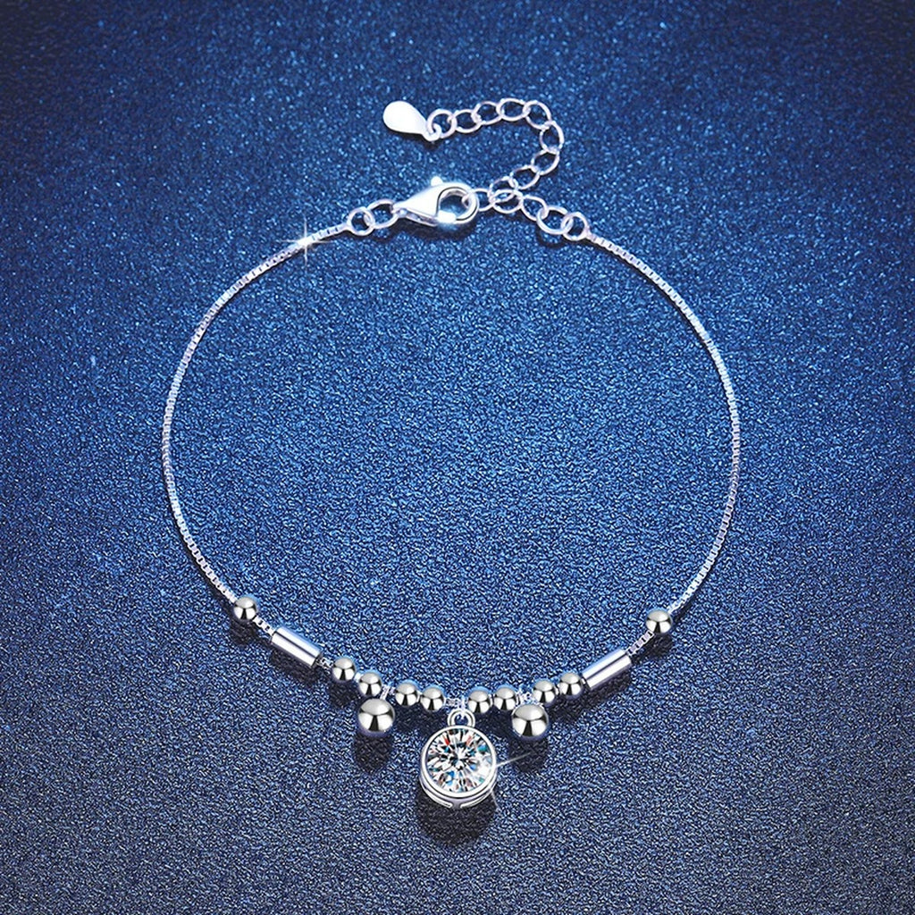 Round Moissanite Charm Bracelet in White Gold-Plated S925 Sterling Silver blue display scene showing bracelet sparkle and chain detail
