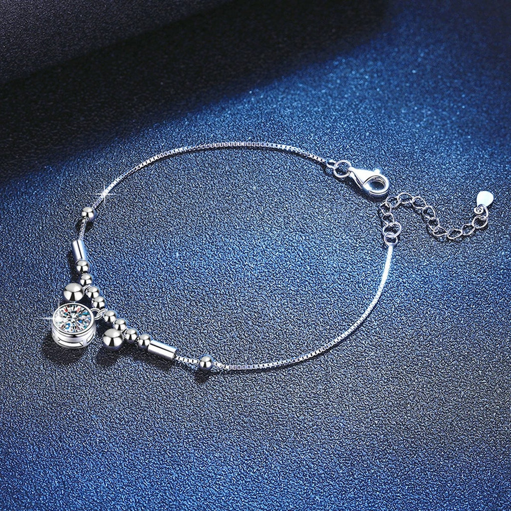 Round Moissanite Charm Bracelet in White Gold-Plated S925 Sterling Silver blue display scene showing bracelet sparkle and chain detail
