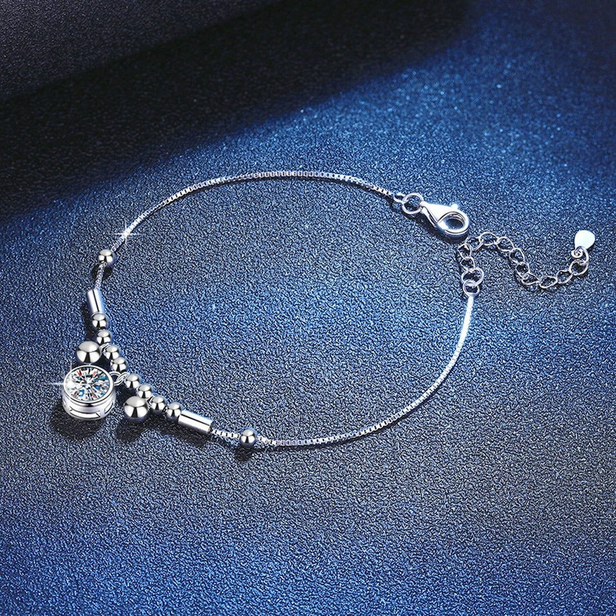 Round Moissanite Charm Bracelet in White Gold-Plated S925 Sterling Silver blue display scene showing bracelet sparkle and chain detail