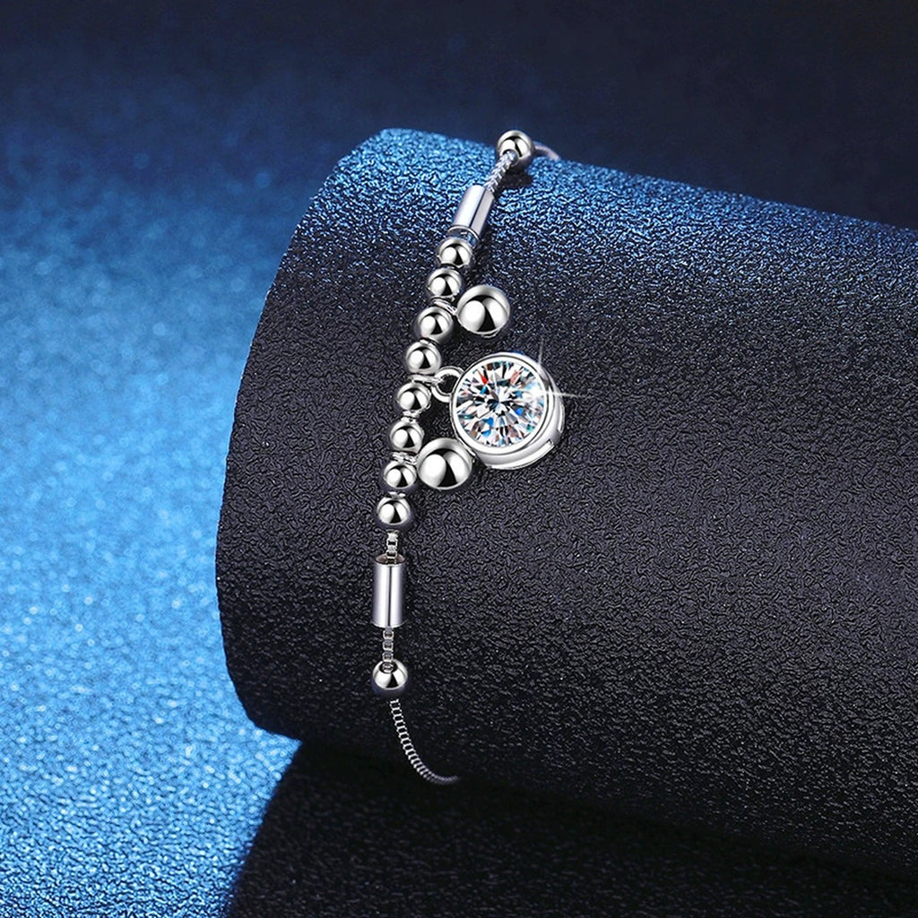 Round Moissanite Charm Bracelet in White Gold-Plated S925 Sterling Silver blue display scene showing bracelet sparkle and chain detail