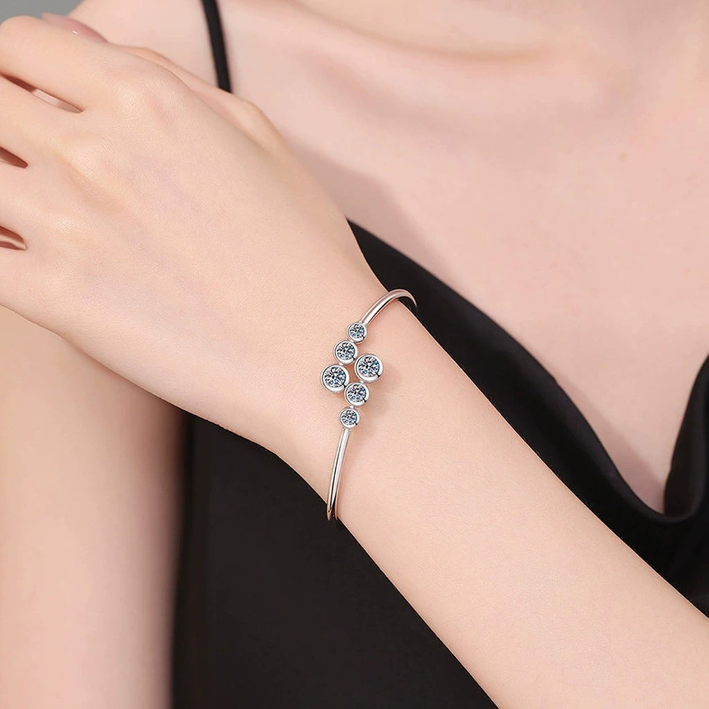 Three-Stone Moissanite Bangle Bracelet in Gold-Plated S925 Sterling Silver worn on wrist model view showing scale and fit
