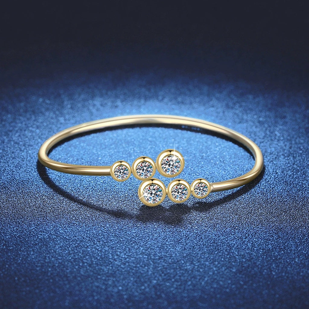 Three-Stone Moissanite Bangle Bracelet in Gold-Plated S925 Sterling Silver blue display scene showing bracelet sparkle and chain detail
