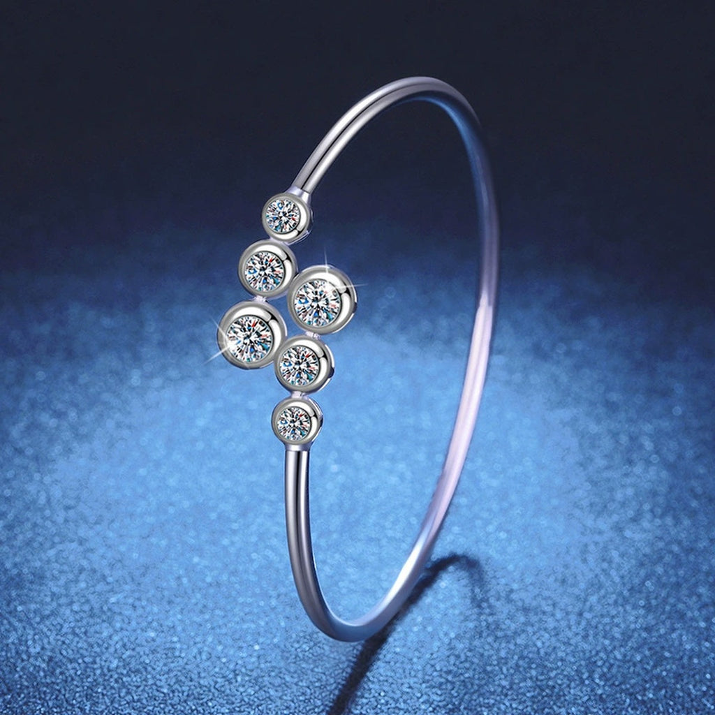 Three-Stone Moissanite Bangle Bracelet in Gold-Plated S925 Sterling Silver blue display scene showing bracelet sparkle and chain detail