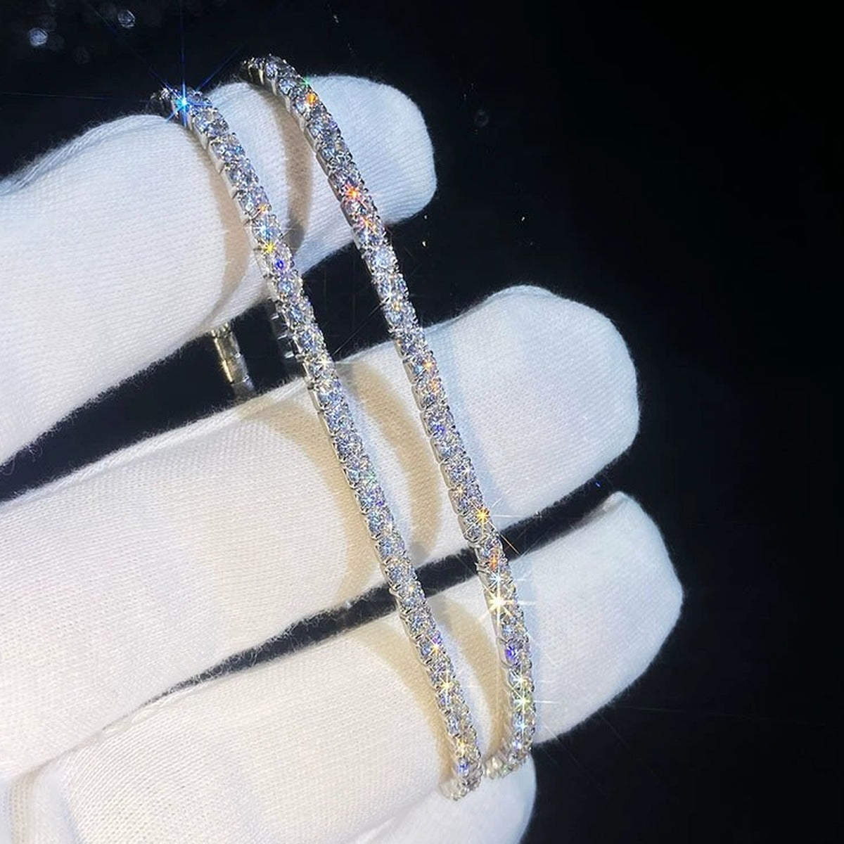 Moissanite Tennis Bangle Bracelet in White Gold-Plated S925 Sterling Silver dark display close-up highlighting stone setting and metal finish