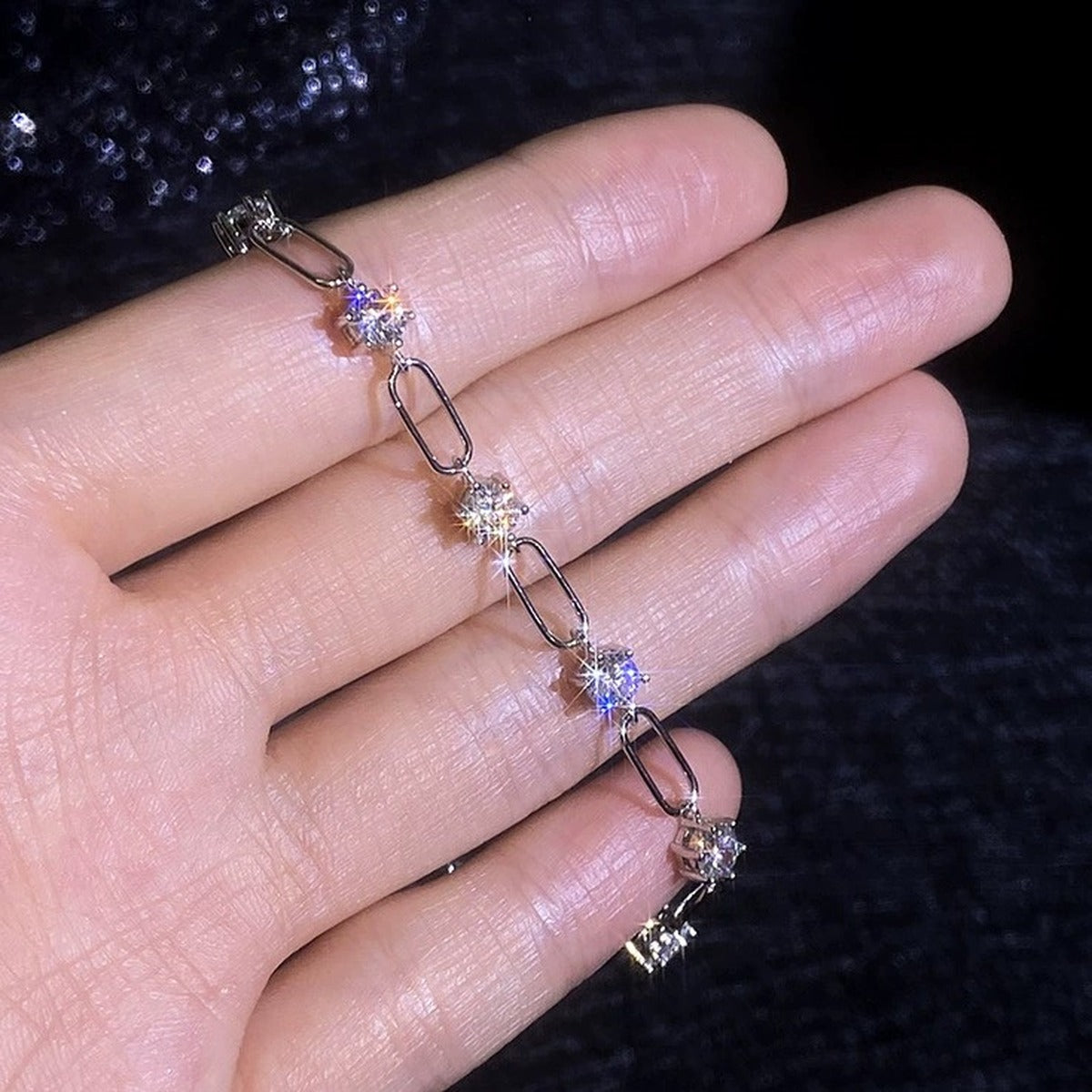Three-Stone Moissanite Chain Bracelet in White Gold-Plated S925 Sterling Silver dark display close-up highlighting stone setting and metal finish