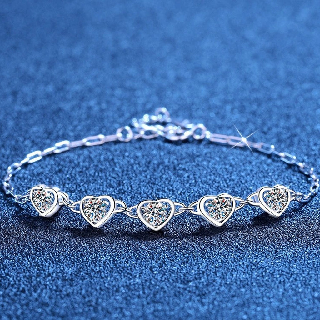 Heart Moissanite Station Bracelet styled on blue display background showing moissanite sparkle and chain detail