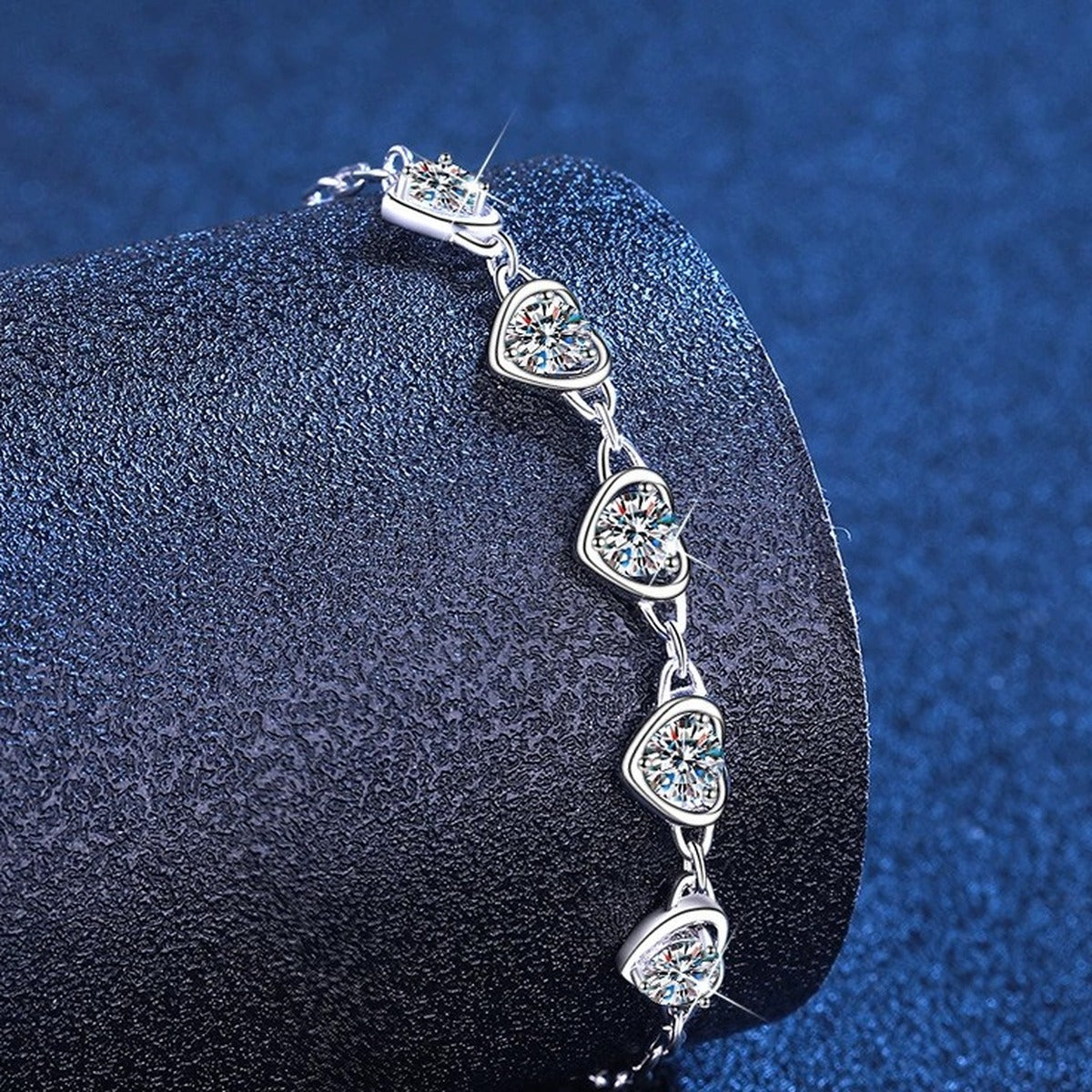 Heart Moissanite Station Bracelet styled on blue display background showing moissanite sparkle and chain detail