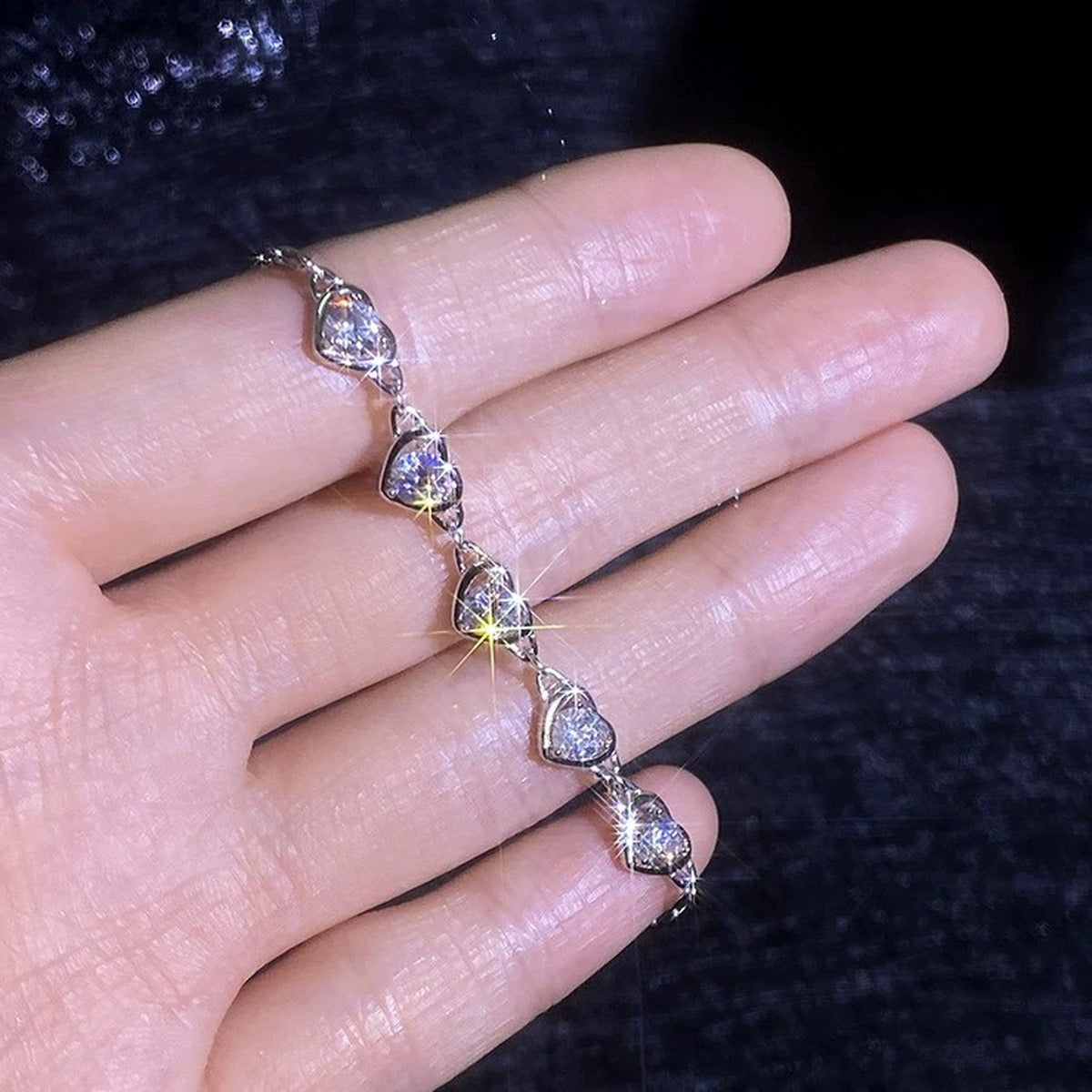 Heart Moissanite Station Bracelet hand-held close-up showing stone detail, width, and bracelet finish