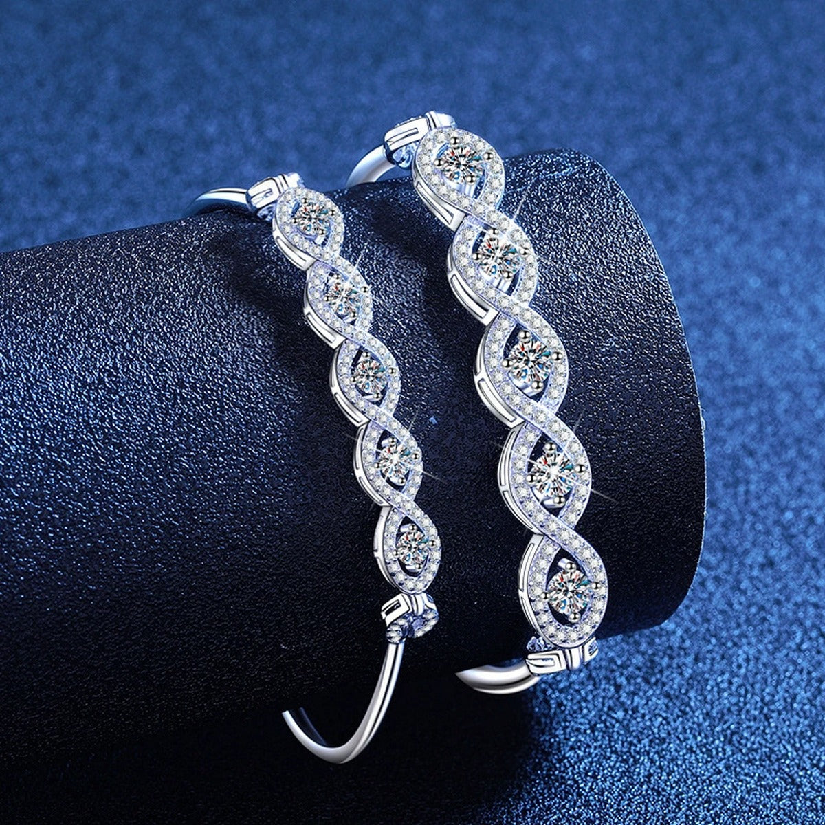 Oval Moissanite Bangle Bracelet with CZ styled on blue display background showing moissanite sparkle and chain detail