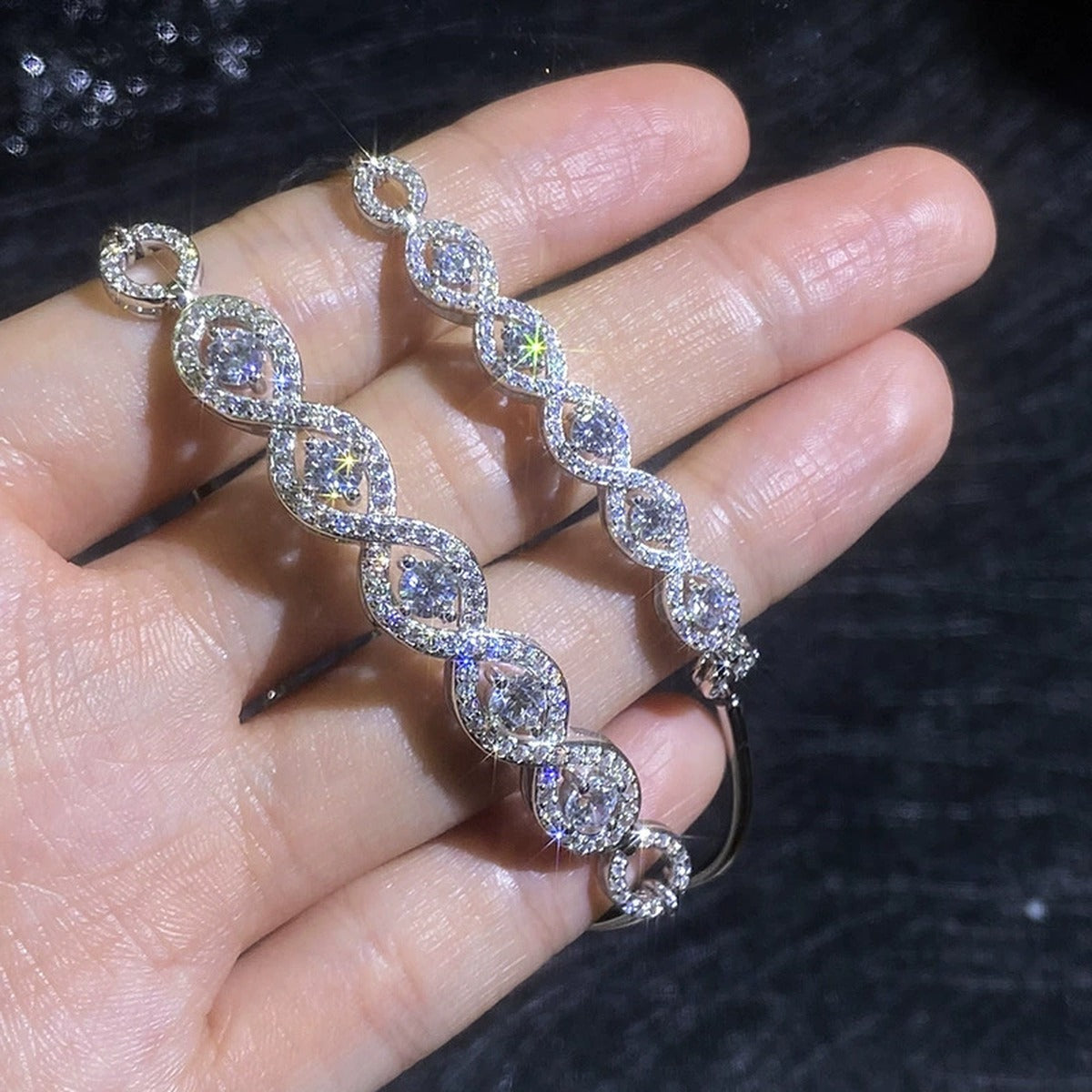 Oval Moissanite Bangle Bracelet with CZ hand-held close-up showing stone detail, width, and bracelet finish