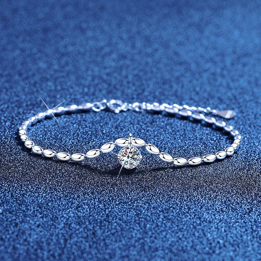Pear Moissanite Chain Bracelet styled on blue display background showing moissanite sparkle and chain detail