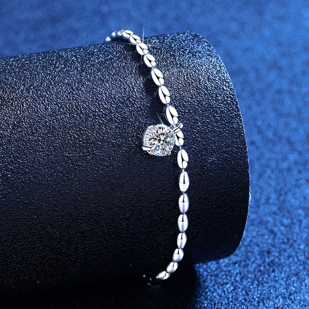 Pear Moissanite Chain Bracelet styled on blue display background showing moissanite sparkle and chain detail