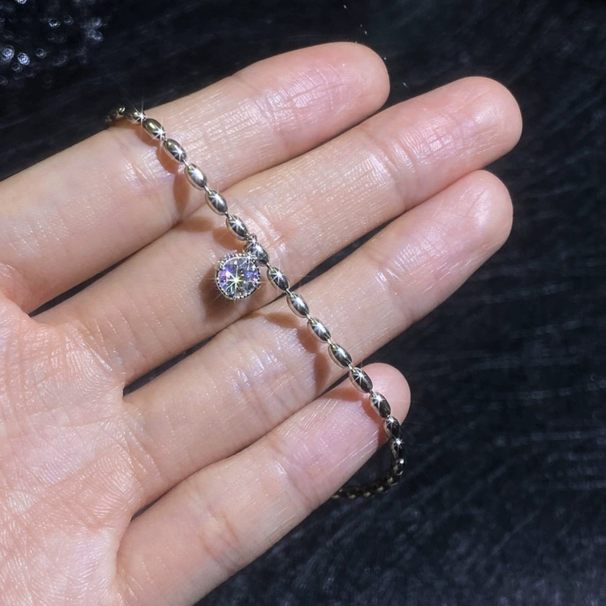 Pear Moissanite Chain Bracelet hand-held close-up showing stone detail, width, and bracelet finish