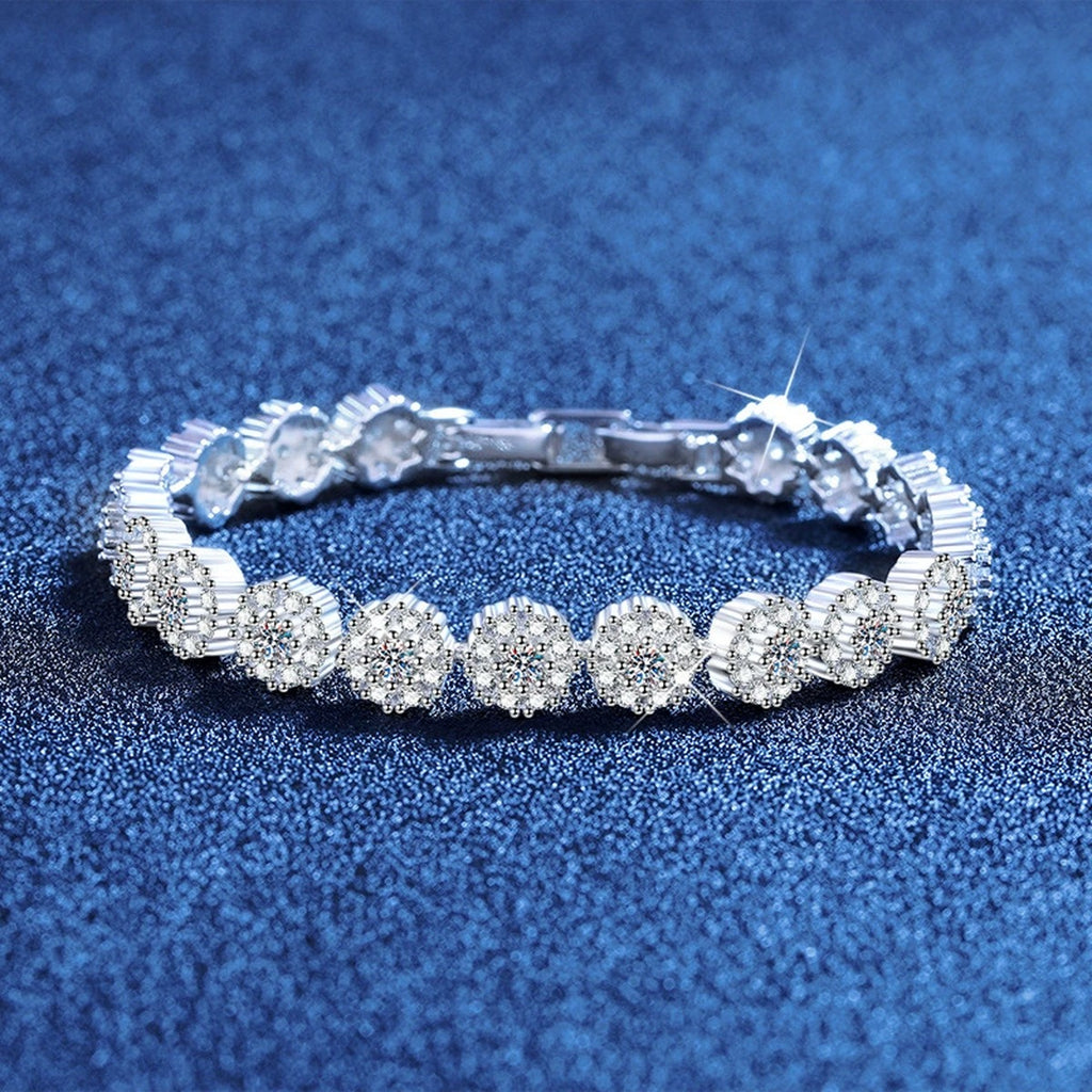 Round Moissanite Tennis Bracelet with CZ styled on blue display background showing moissanite sparkle and chain detail