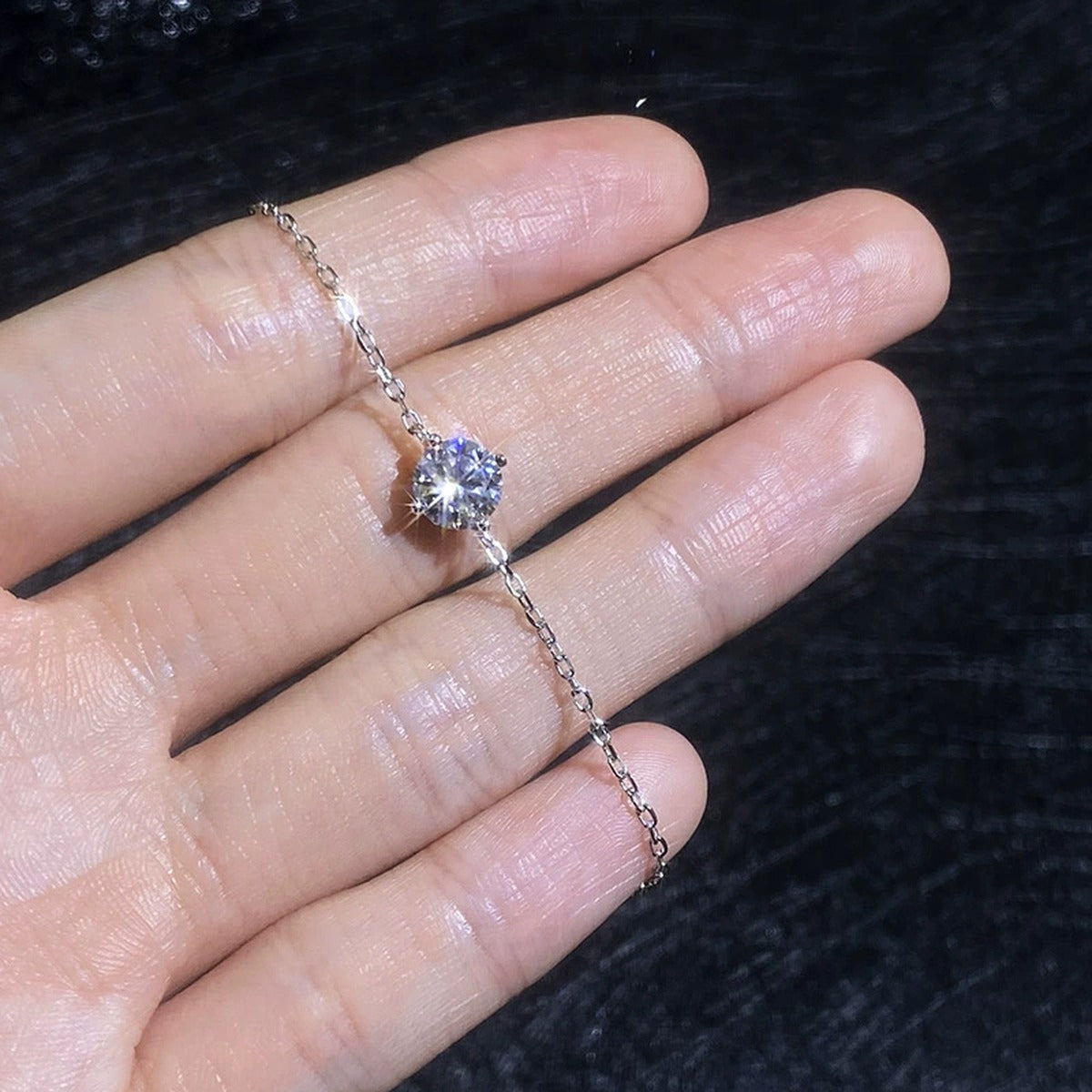 Round Moissanite Chain Bracelet hand-held close-up showing stone detail, width, and bracelet finish