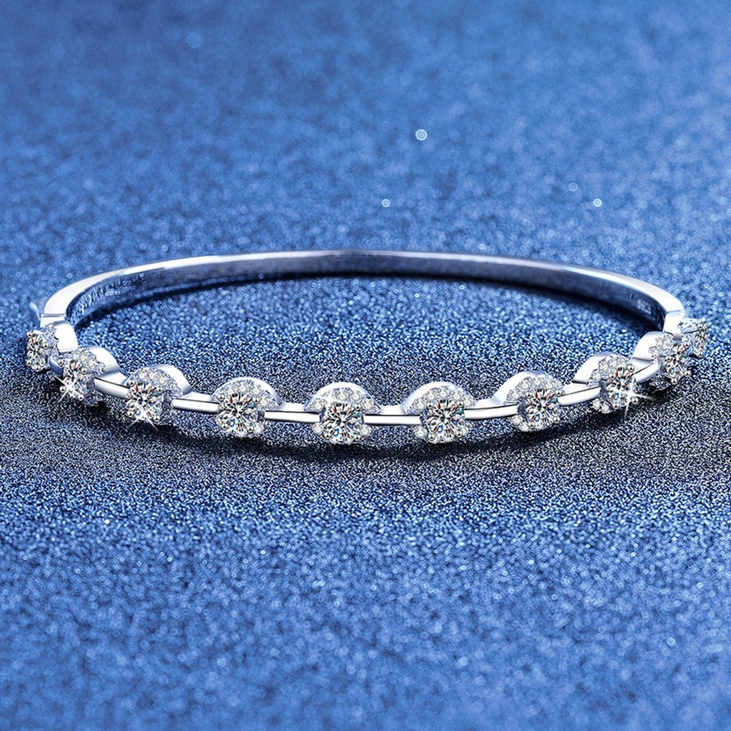 Bezel Moissanite Bangle Bracelet styled on blue display background showing moissanite sparkle and chain detail