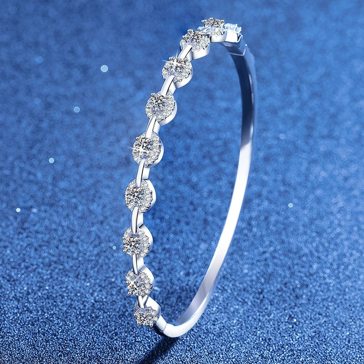 Bezel Moissanite Bangle Bracelet styled on blue display background showing moissanite sparkle and chain detail