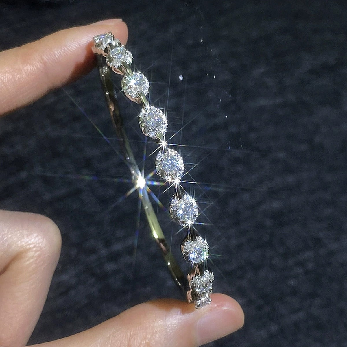 Bezel Moissanite Bangle Bracelet hand-held close-up showing stone detail, width, and bracelet finish