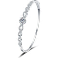 Round Moissanite Bangle Bracelet with CZ white background product photo showing bracelet silhouette and moissanite setting