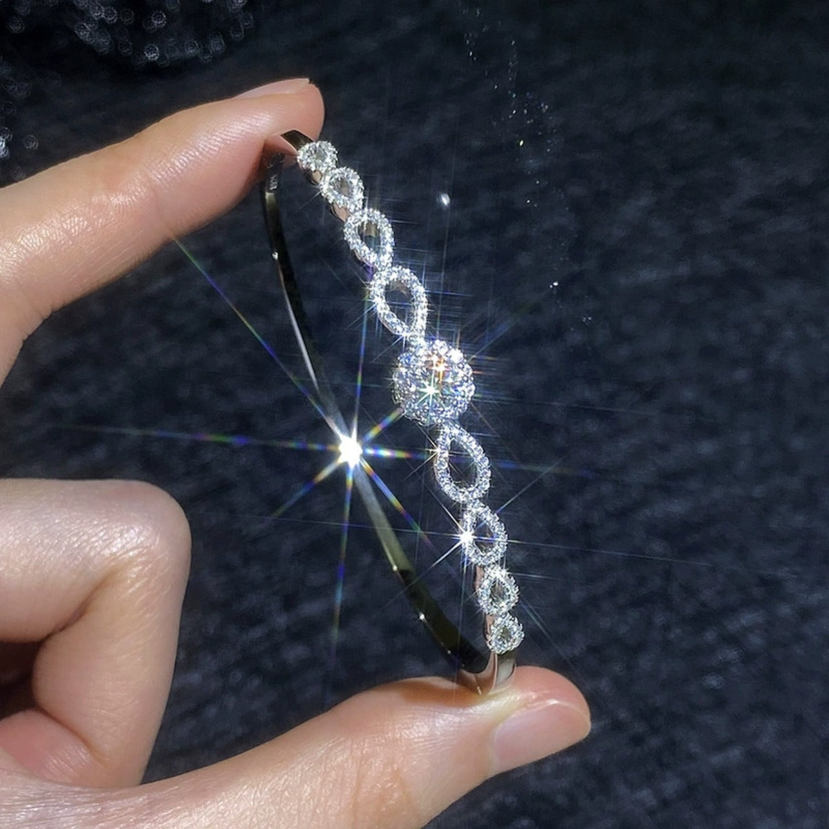 Round Moissanite Bangle Bracelet with CZ hand-held close-up showing stone detail, width, and bracelet finish