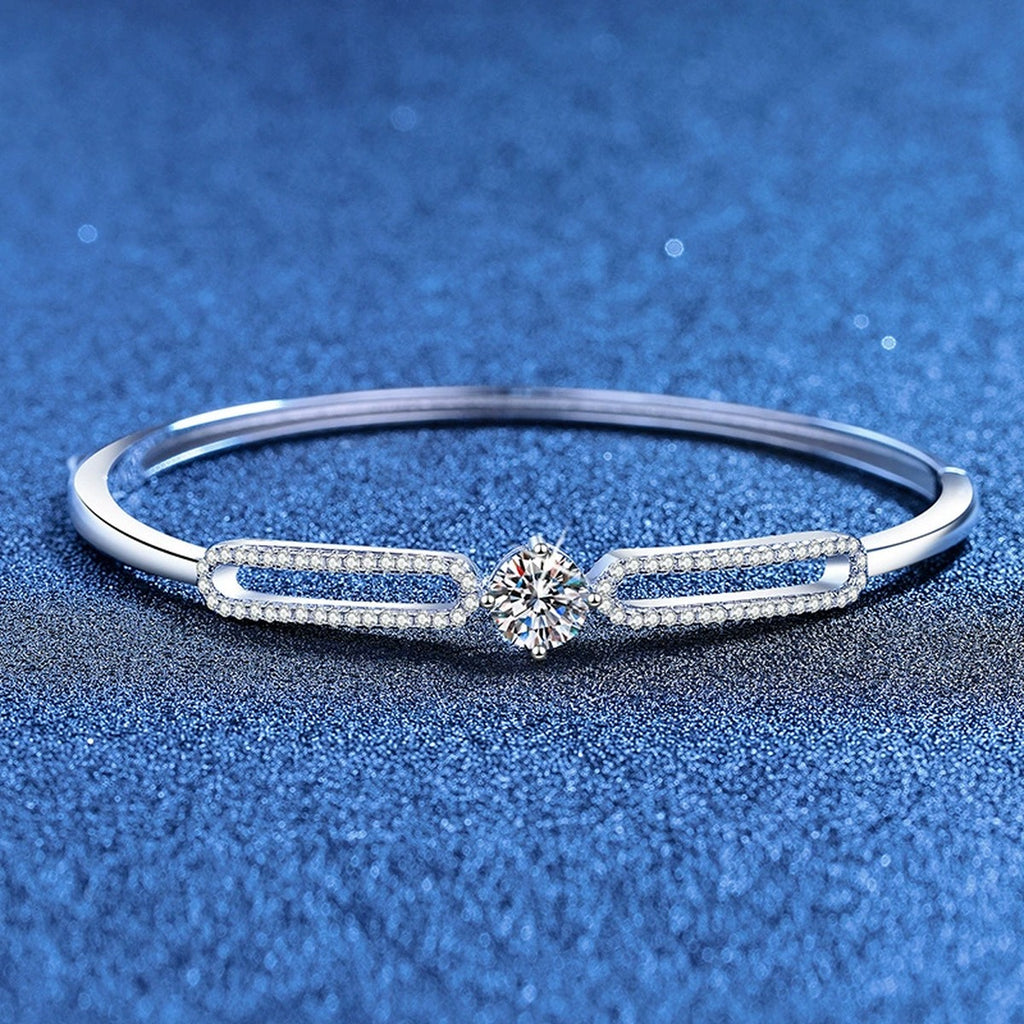 Paperclip Moissanite Bangle Bracelet with CZ styled on blue display background showing moissanite sparkle and chain detail
