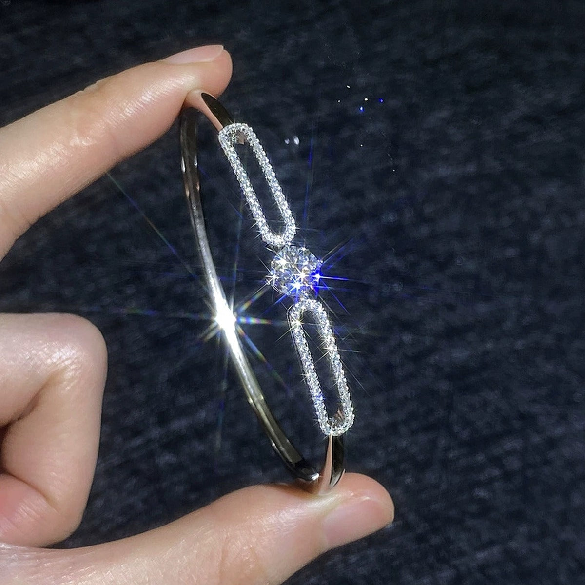 Paperclip Moissanite Bangle Bracelet with CZ hand-held close-up showing stone detail, width, and bracelet finish