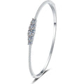 Graduated Moissanite Bangle Bracelet with CZ white background product photo showing bracelet silhouette and moissanite setting