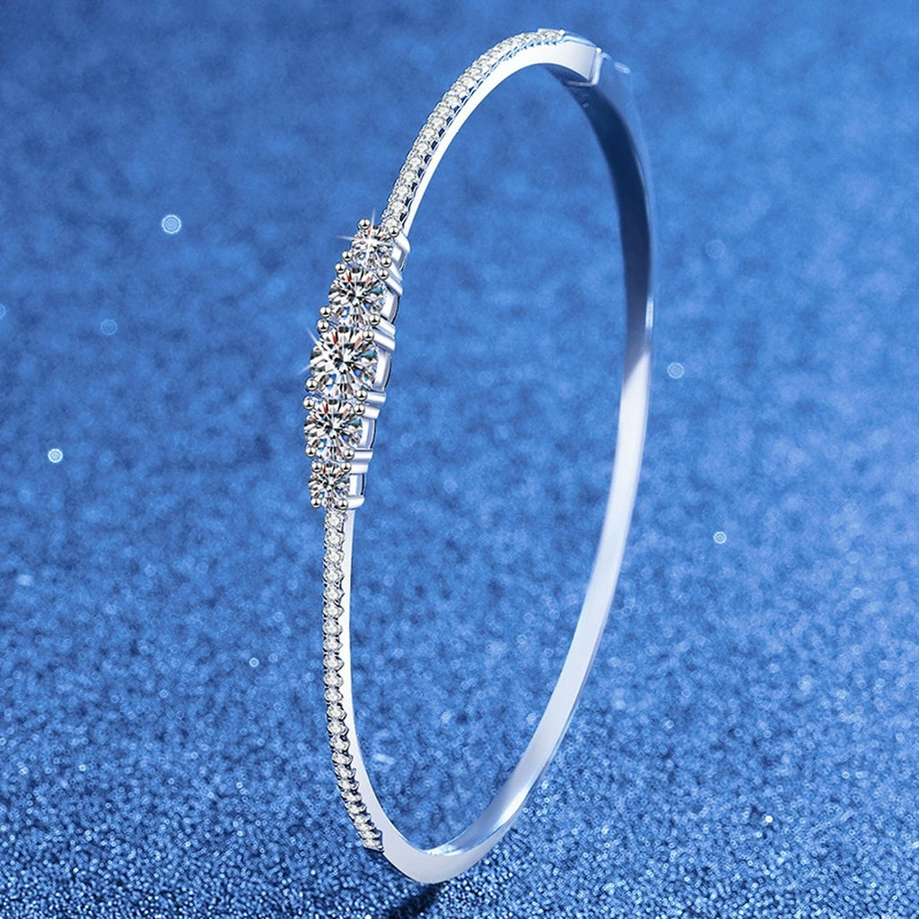 Graduated Moissanite Bangle Bracelet with CZ styled on blue display background showing moissanite sparkle and chain detail