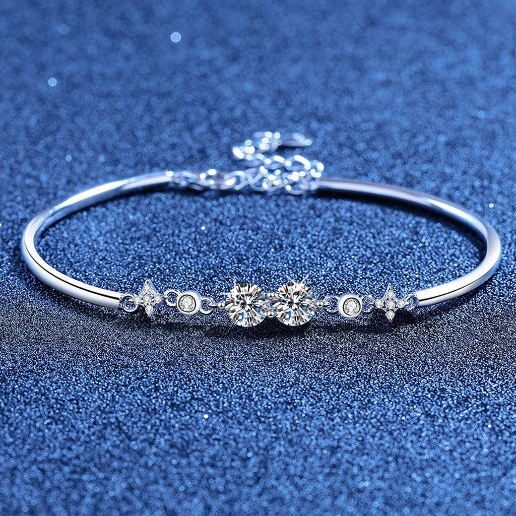 Round Moissanite Adjustable Bangle Bracelet with CZ styled on blue display background showing moissanite sparkle and chain detail