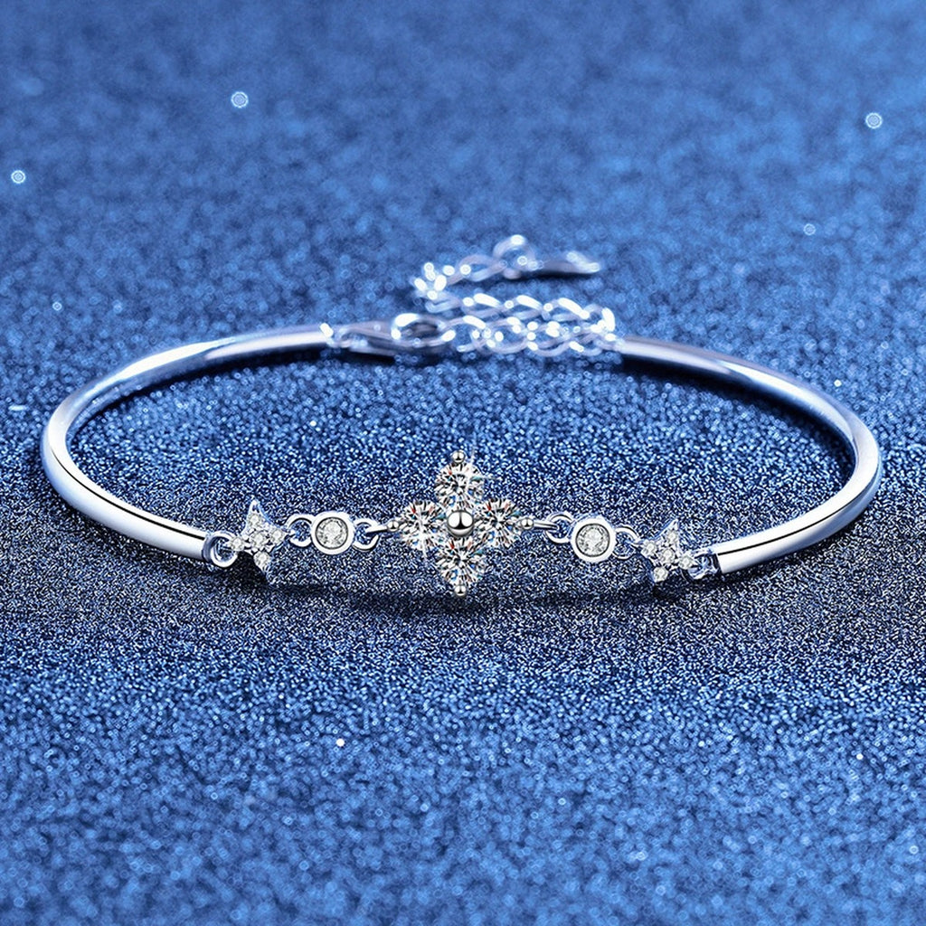 Floral Moissanite Adjustable Bangle Bracelet with CZ styled on blue display background showing moissanite sparkle and chain detail
