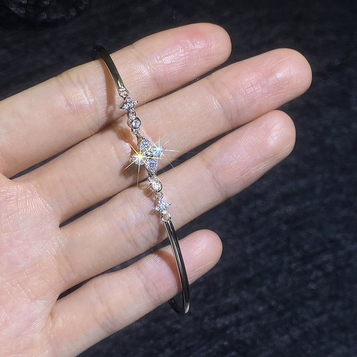 Floral Moissanite Adjustable Bangle Bracelet with CZ hand-held close-up showing stone detail, width, and bracelet finish