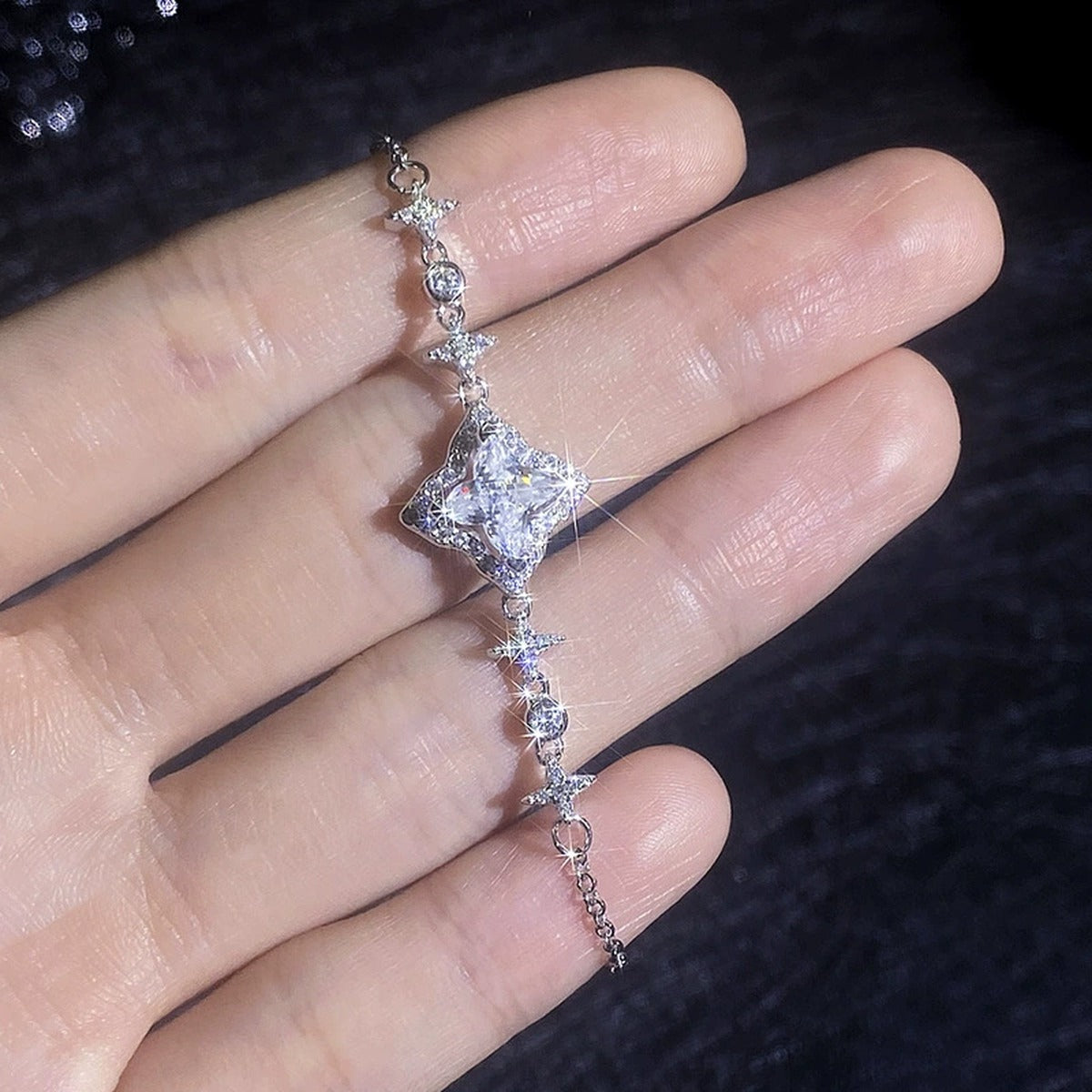 Star Cut Moissanite Adjustable Bracelet with CZ hand-held close-up showing stone detail, width, and bracelet finish