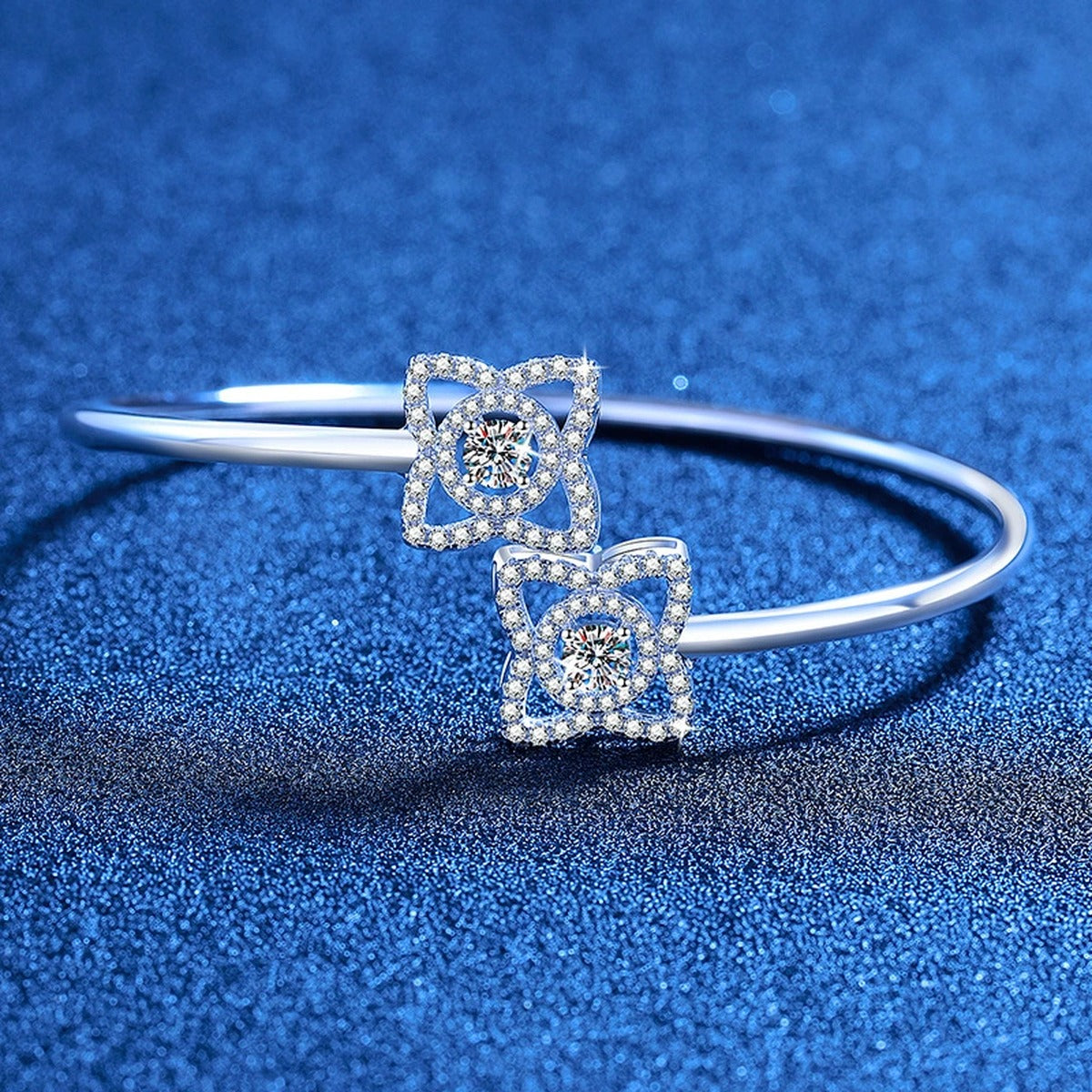 Two-Stone Moissanite Adjustable Bangle Bracelet with CZ styled on blue display background showing moissanite sparkle and chain detail