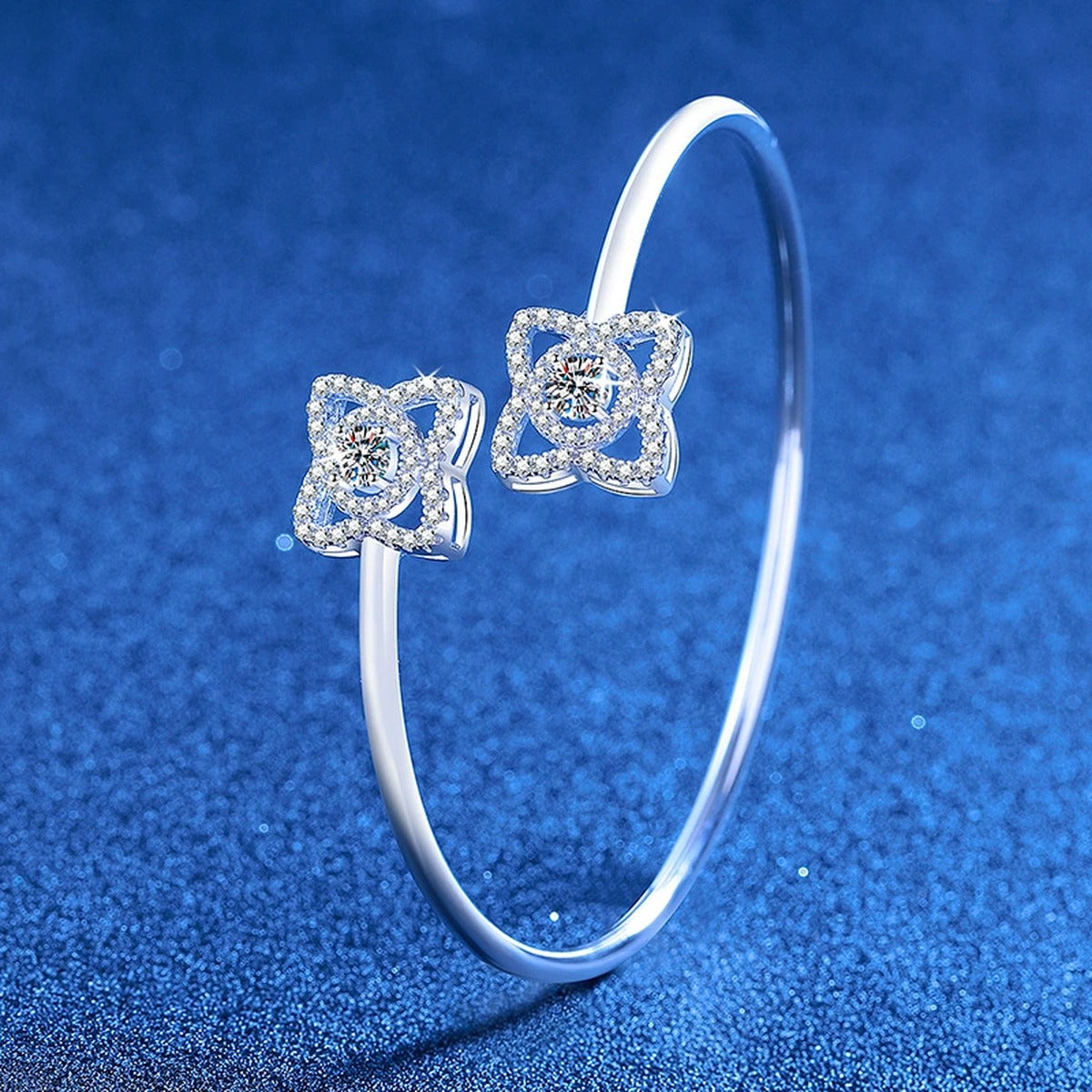 Two-Stone Moissanite Adjustable Bangle Bracelet with CZ styled on blue display background showing moissanite sparkle and chain detail