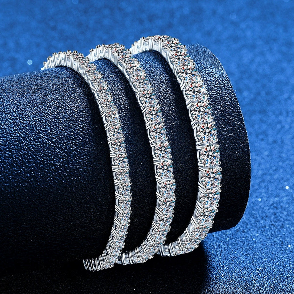 Round Moissanite Tennis Bracelet styled on blue display background showing moissanite sparkle and chain detail