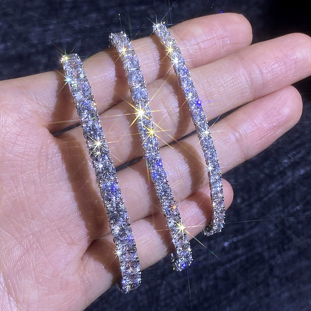 Round Moissanite Tennis Bracelet hand-held close-up showing stone detail, width, and bracelet finish