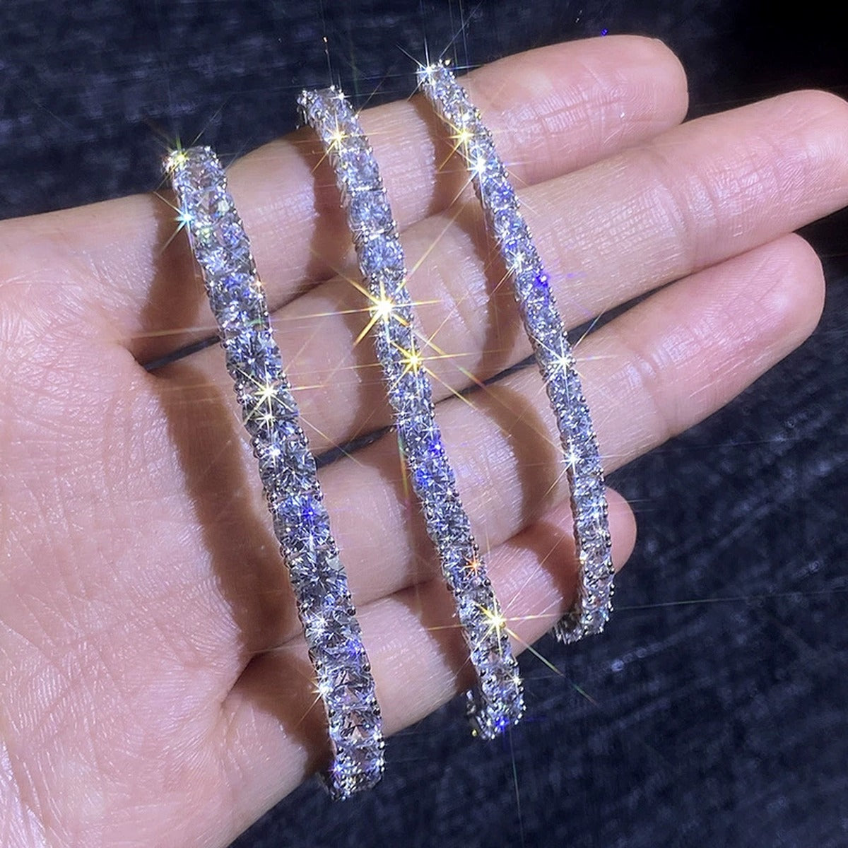 Round Moissanite Tennis Bracelet hand-held close-up showing stone detail, width, and bracelet finish