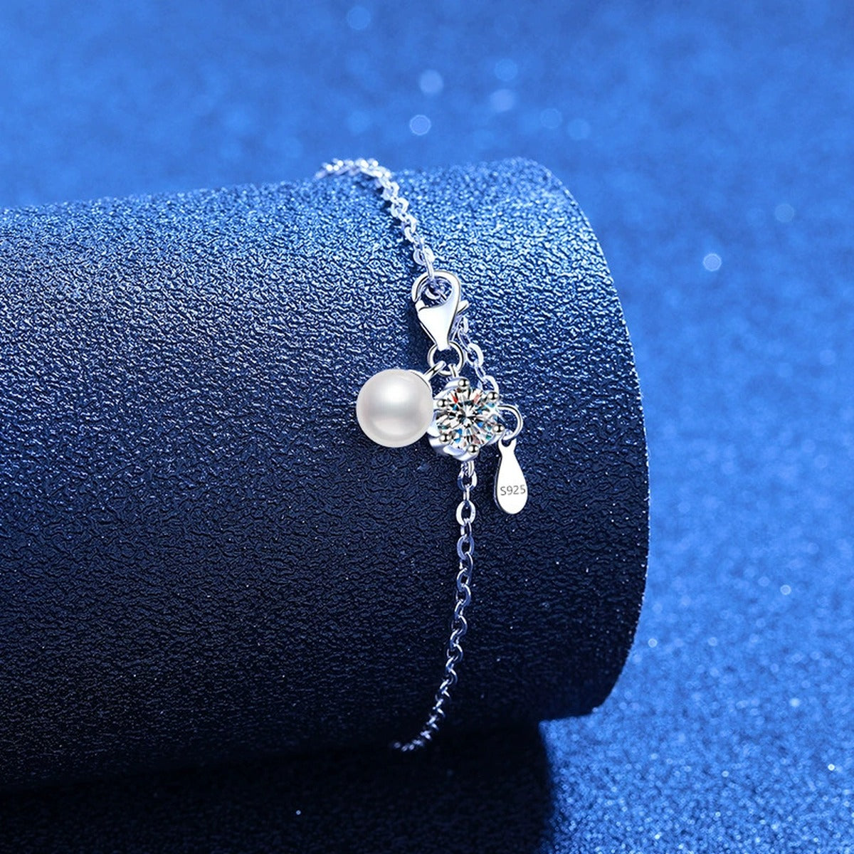 Pearl and Moissanite Chain Bracelet styled on blue display background showing moissanite sparkle and chain detail