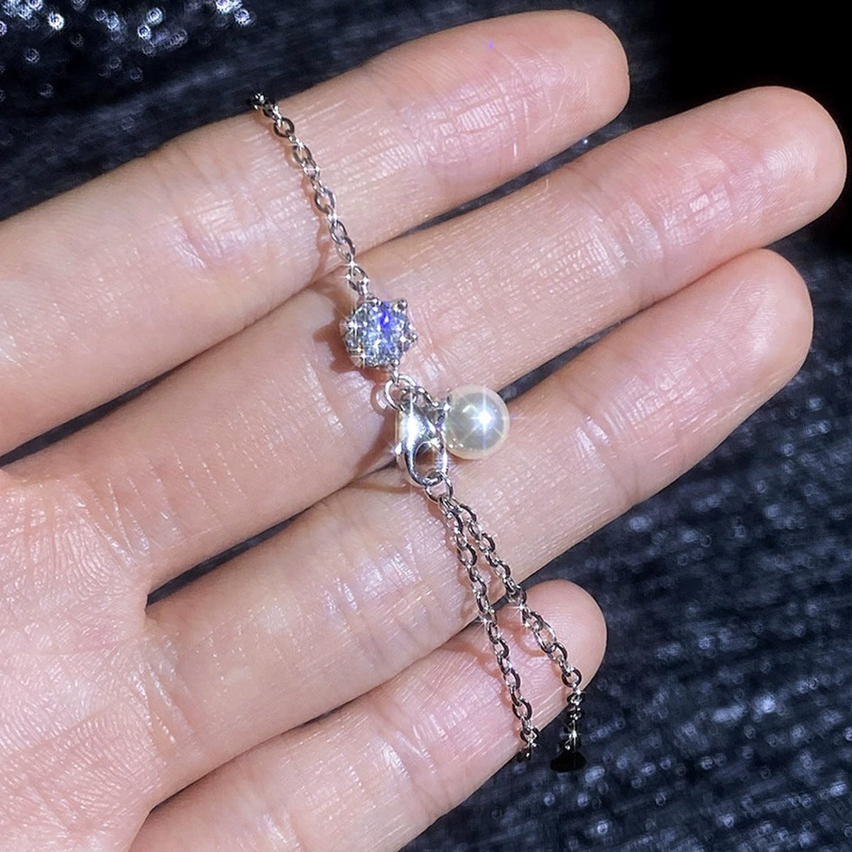 Pearl and Moissanite Chain Bracelet hand-held close-up showing stone detail, width, and bracelet finish