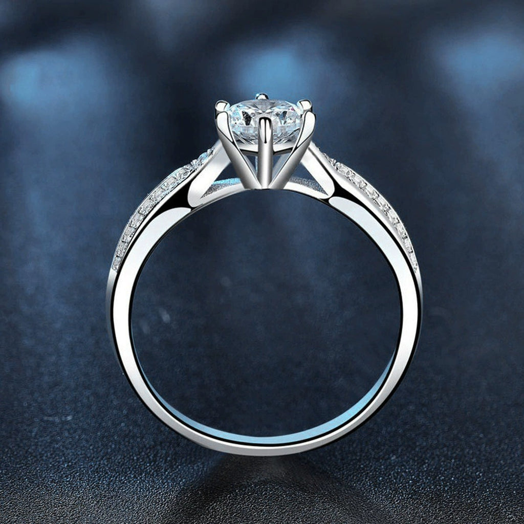 Six-Prong Round Moissanite Engagement Ring with CZ close-up detail view with moissanite sparkle