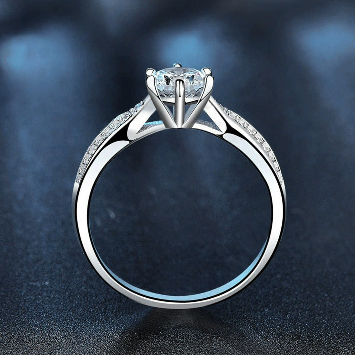Six-Prong Round Moissanite Engagement Ring with CZ close-up detail view with moissanite sparkle