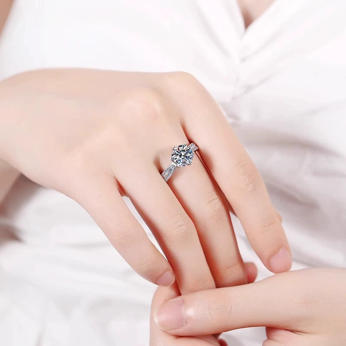 Starburst Six-Prong Round Moissanite Engagement Ring with CZ worn on hand to show scale, band width, and ring profile