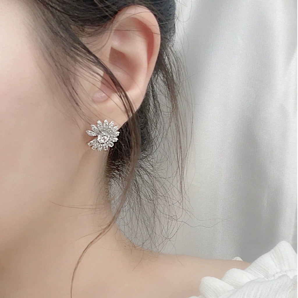 Daisy Round Moissanite Stud Earrings with CZ in White Gold-Plated S925 sterling silver worn on ear by model showing scale, placement, and stud earrings styling
