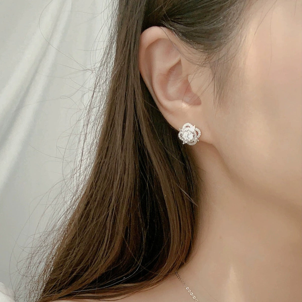 Star Round Moissanite Stud Earrings with CZ in White Gold-Plated S925 sterling silver worn on ear by model showing scale, placement, and stud earrings styling