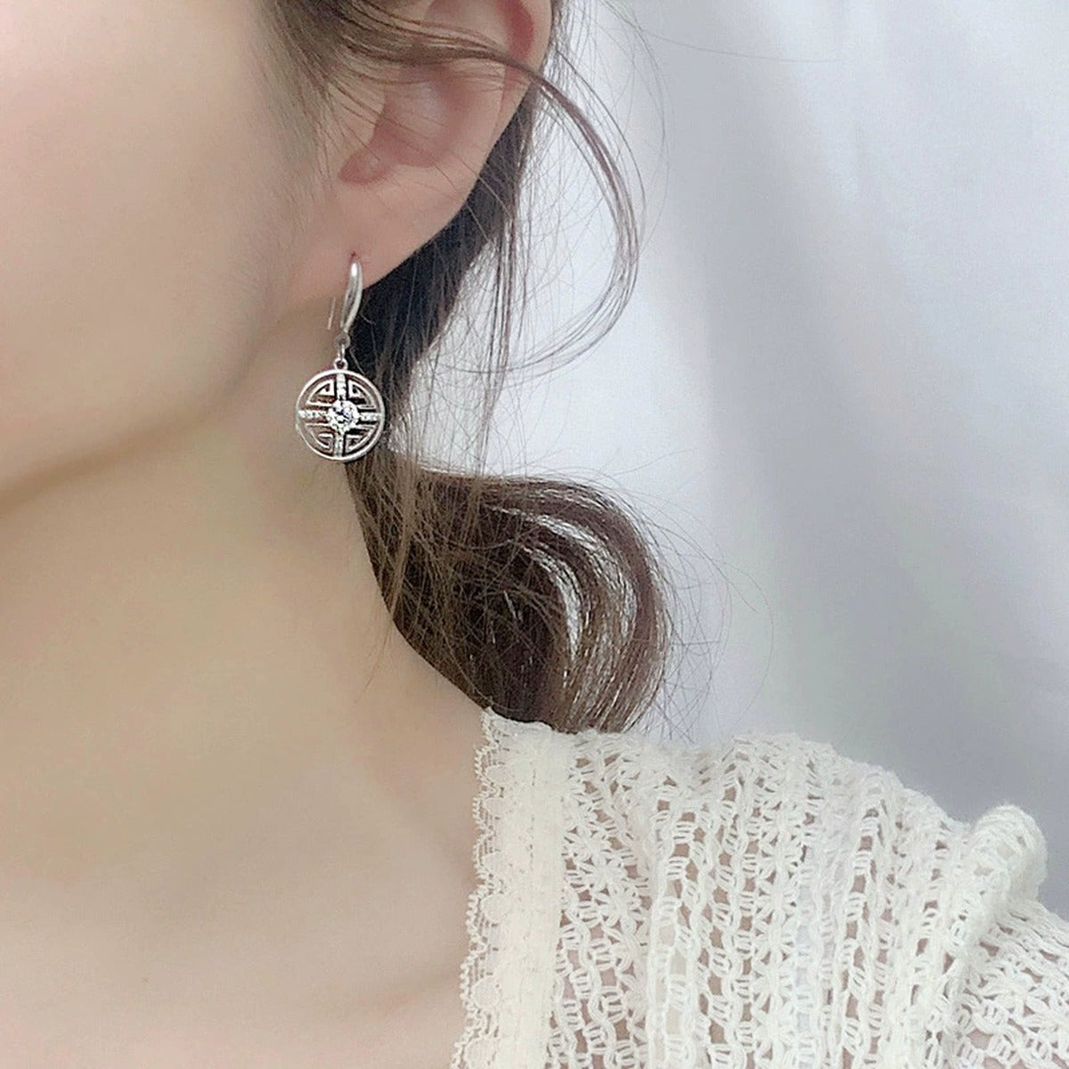 Longevity Motif Round Moissanite Hook Dangle Earrings with CZ in White Gold-Plated S925 sterling silver worn on ear by model showing scale, placement, and hook dangle earrings styling