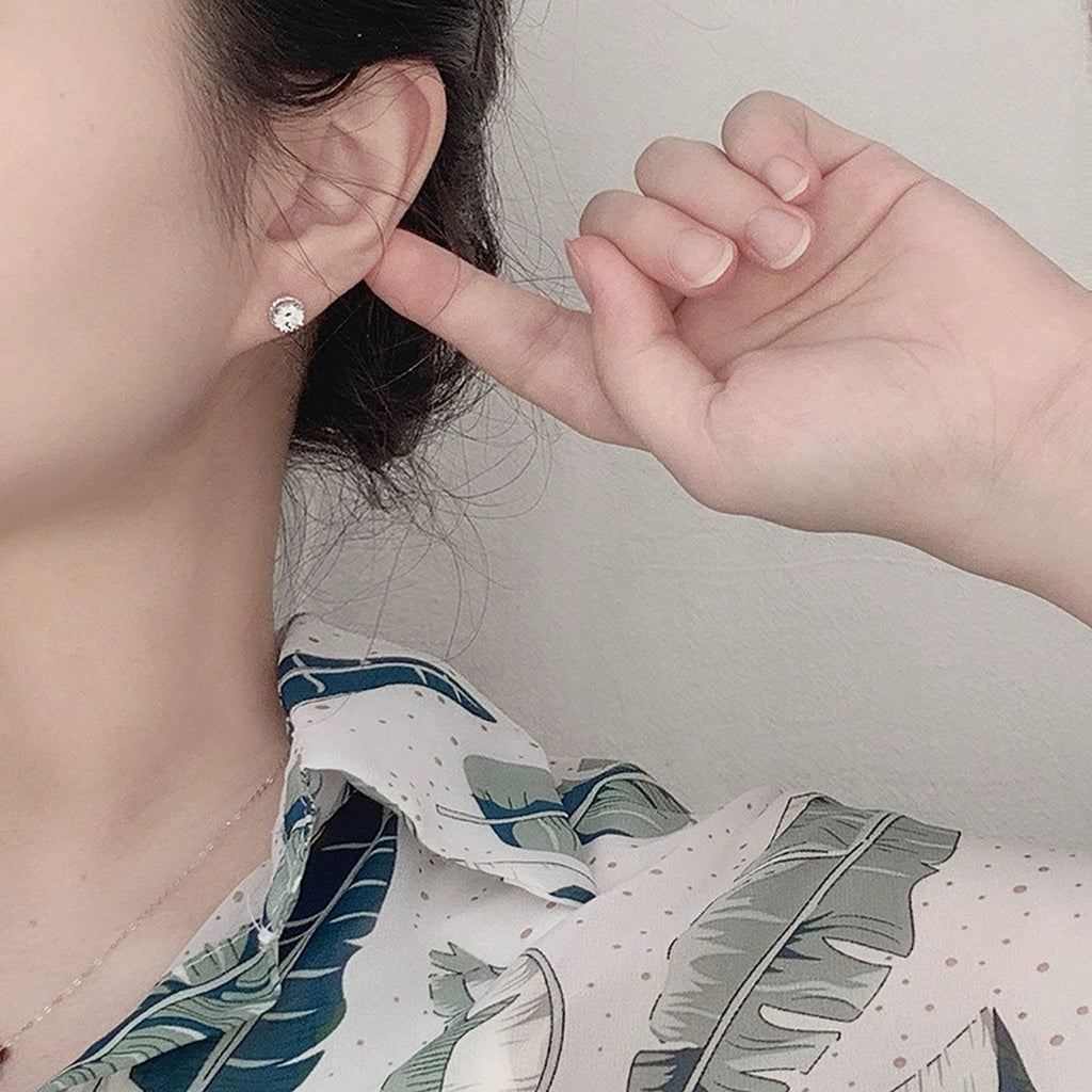 Floral Halo Round Moissanite Stud Earrings in White Gold-Plated S925 sterling silver worn on ear by model showing scale, placement, and stud earrings styling