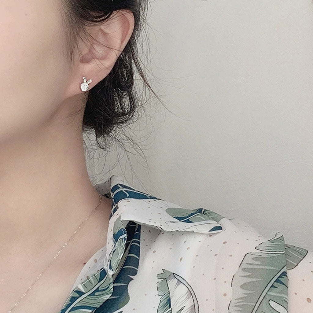 Rabbit Round Moissanite Stud Earrings with CZ in White Gold-Plated S925 sterling silver worn on ear by model showing scale, placement, and stud earrings styling