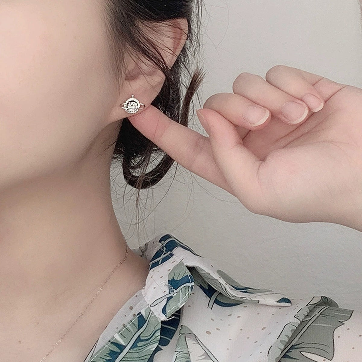 Planet Round Moissanite Stud Earrings with CZ in White Gold-Plated S925 sterling silver worn on ear by model showing scale, placement, and stud earrings styling
